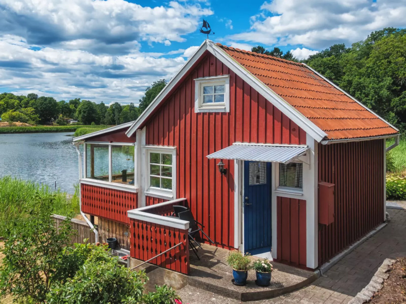 Rood huisje aan het water in Zweden