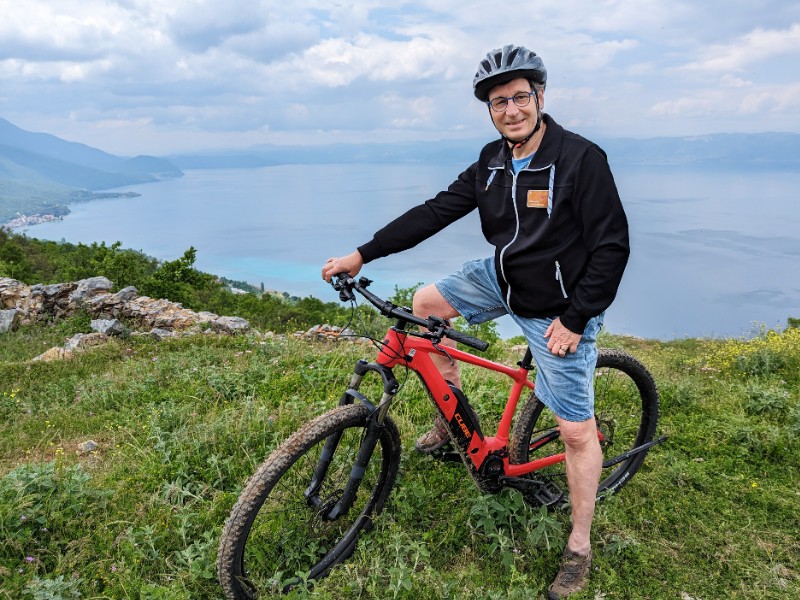 Patrick op de mountainbike bij een uitzicht over het meer van Ohrid