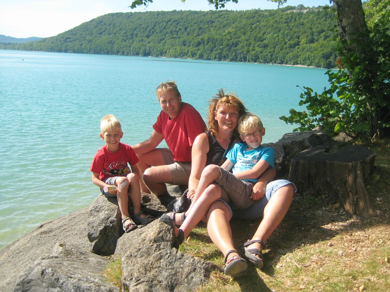 Ons gezin voor het blauwe water van Lac de Chalain
