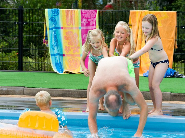 Kids duwen papa in het zwembad