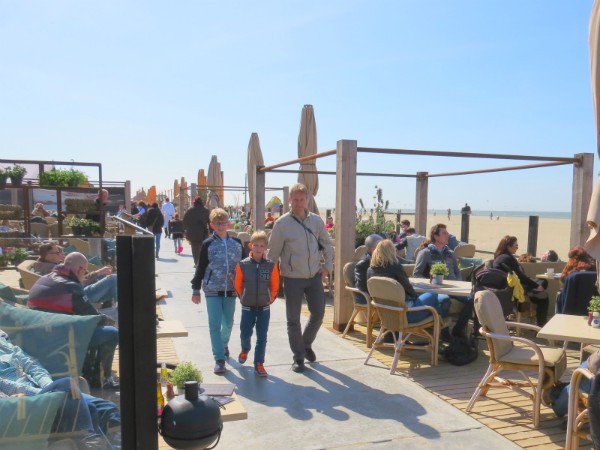 Vader en zoons wandelen langs het strand en terrasjes in Scheveningen