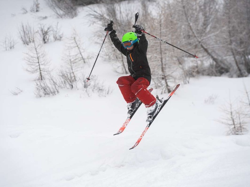 Wintersport kind springt met skies 