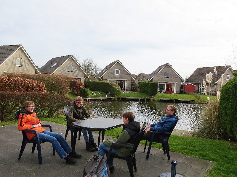 De jongens hebben pret op het terras aan het water bij Bungalowpark Zuiderzee